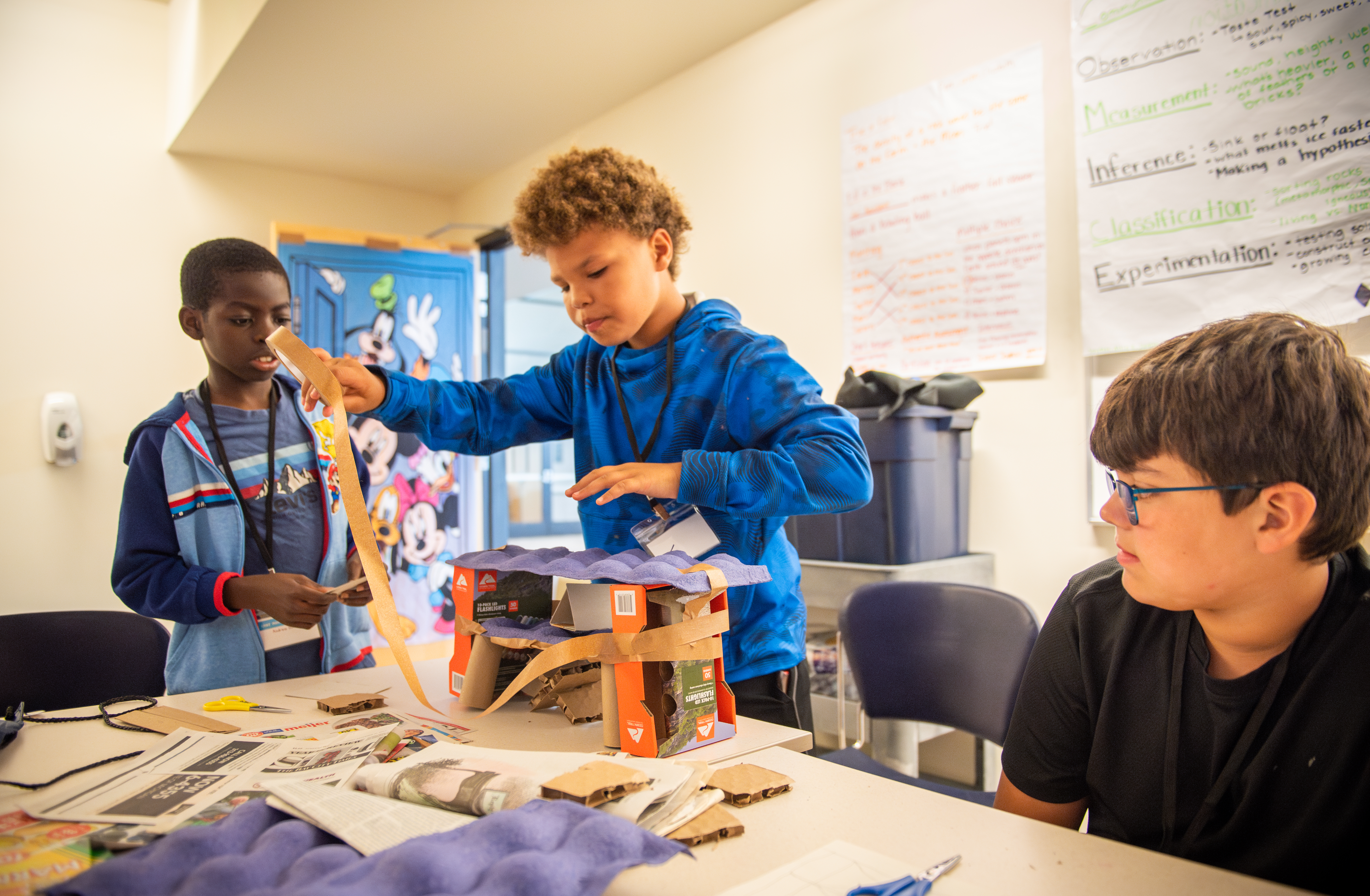 Student engineering with egg cartons.